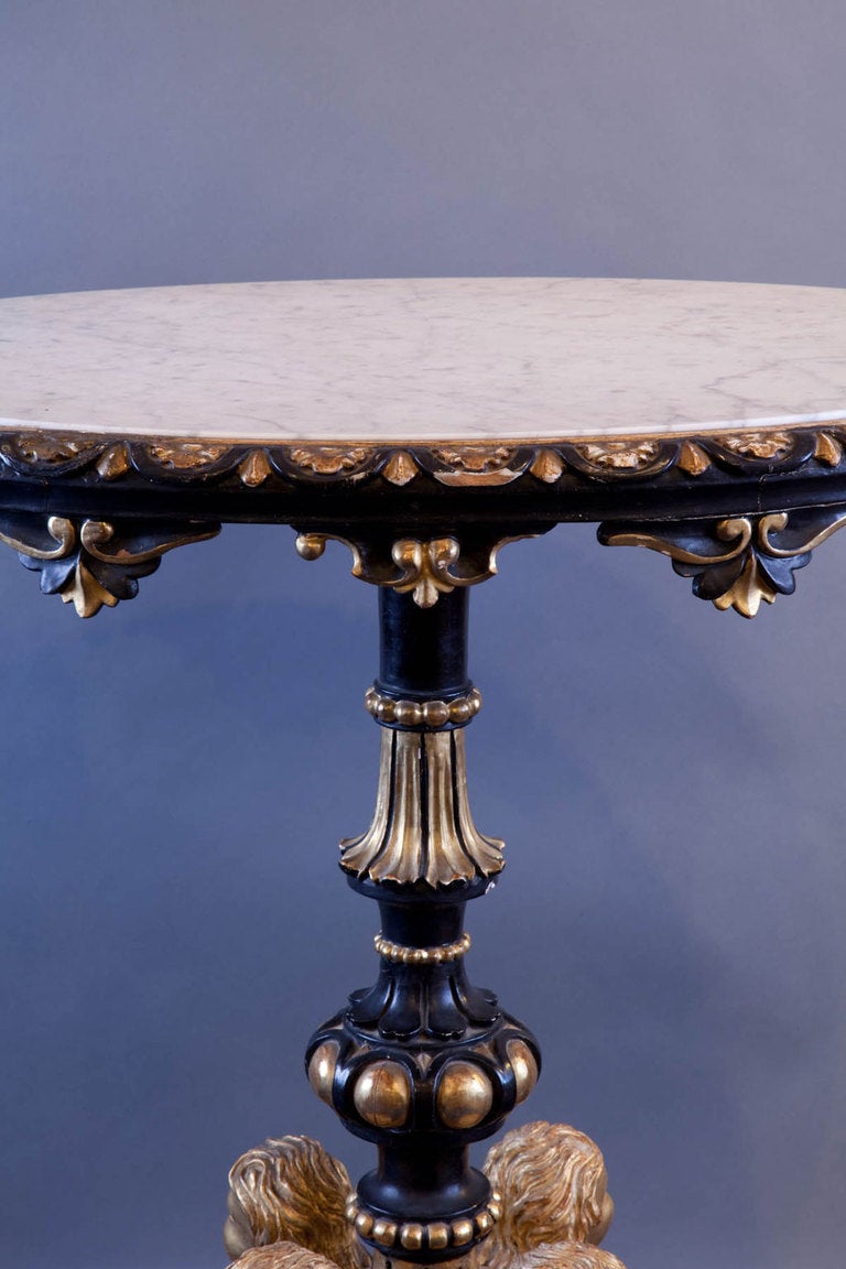 Sensational late 18th-early 19th century ornate Italian carved gilt wood table, with four angels on the pedestal base, the whole with scroll and acanthus leaf decoration and an inset white Carrera marble oval top.