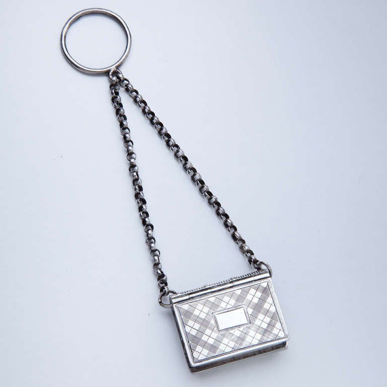 Sterling silver book form Vinaigrette, suspended on chain, by John Taylor & John Perry, Birmingham, England. Four inches suspended on chain.