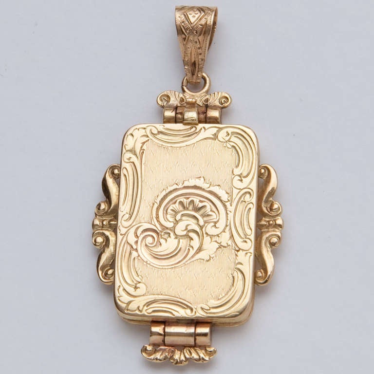 In the form of a locket, the front and back engraved with scroll decoration, the grille with bright-cut scroll & floral designs, sides all flanked by extended scroll decoration. Interior lined with blue fabric. Cover and grille hallmarked with a