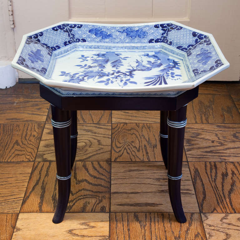 Early 19th century Japanese Blue and White Arita deep platter, depicting a bird perched in a blossoming tree, with Greek key border. Set on a custom made wooden table. Platter measures: 2.75