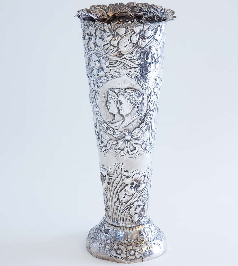 A wonderful German silver (.800) tall footed vase decorated in repoussé technique with double-head portrait medallion. Marks for Hanau, probably by Georg Roth.