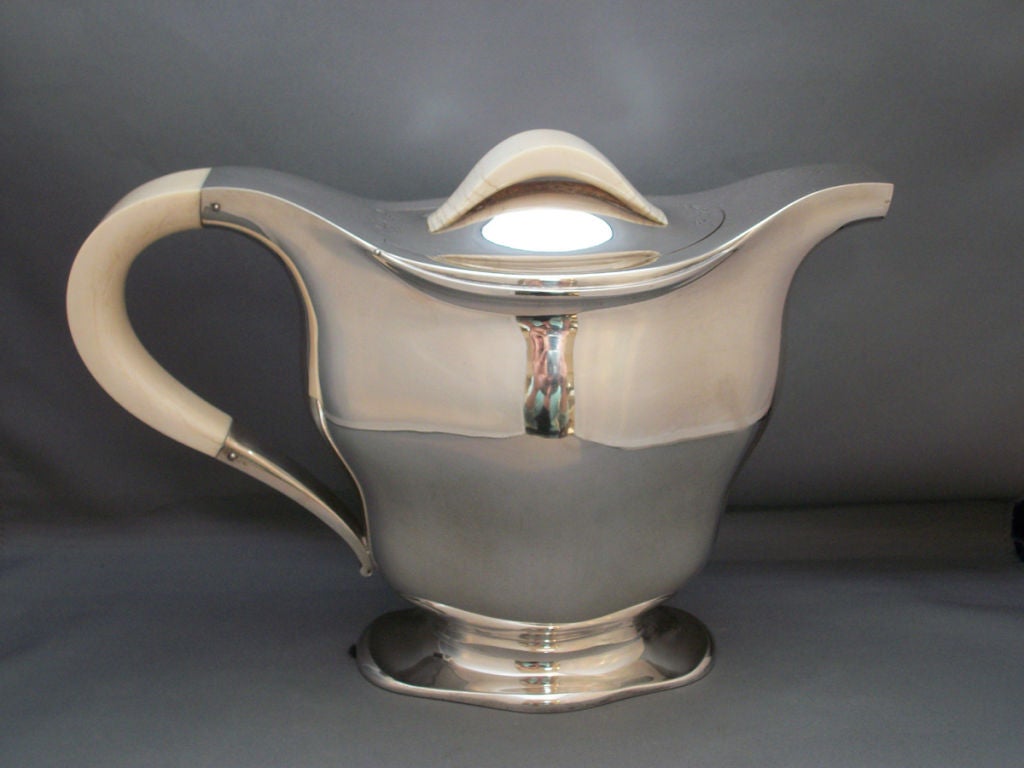 Sensational Art Deco Continental sterling .800, coffee and tea service of bombe-form with tray. The coffee pot, tea pot, covered sugar and creamer with bone handles and finials. Makers mark: Delheid Freres, Brussels, c. 1930. 

PROVENANCE: Art