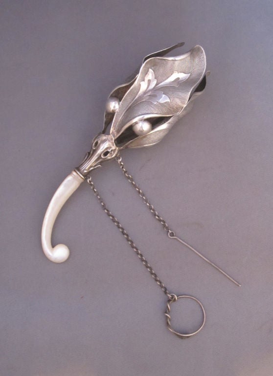 Wonderful Victorian sterling silver Tussie Mussie (Posy Holder), the cup of open leaf form with ball separators, original mother of pearl handle, with finger ring and pin on chain.  As seen in Book: Tussie Mussies, Victorian Posy Holders, by Jeri