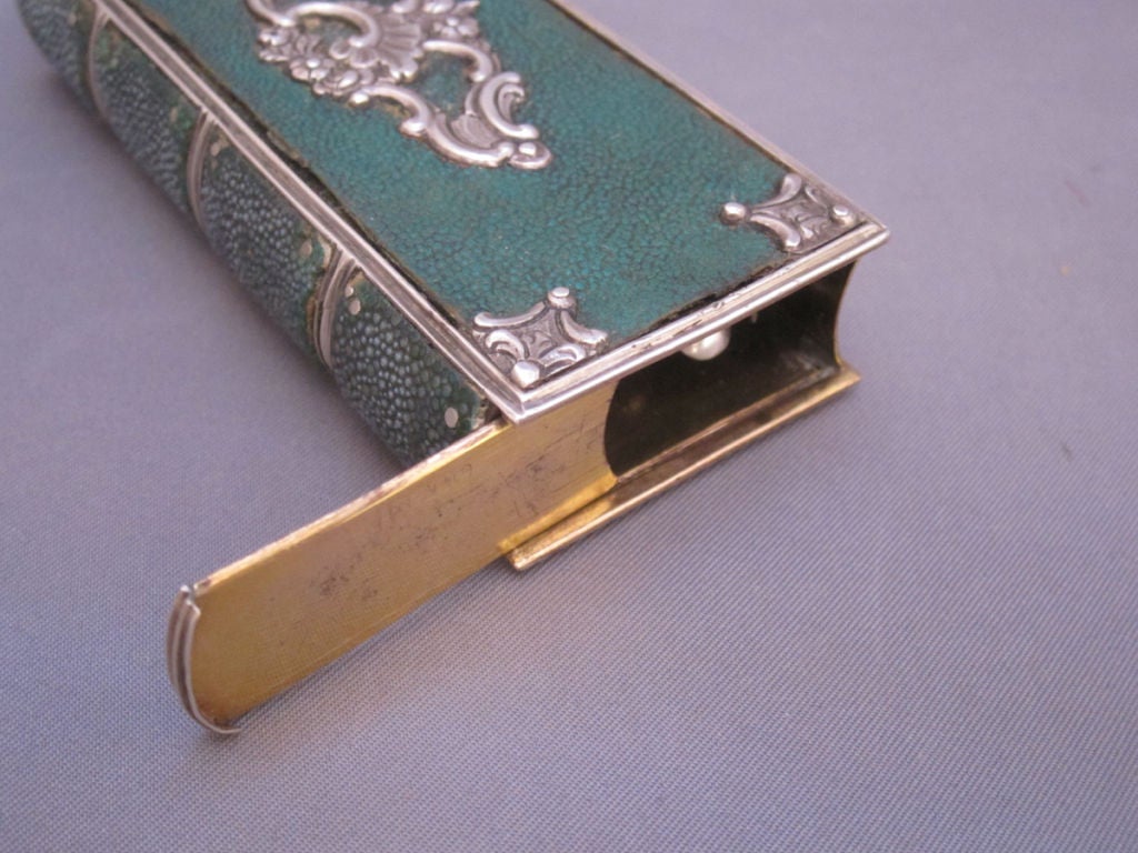 Exquisite and rare mid nineteenth century shagreen and sterling silver book form etui, fitted with scissors, pencil, bone writing surface, picks, spoon and a pocket knife.