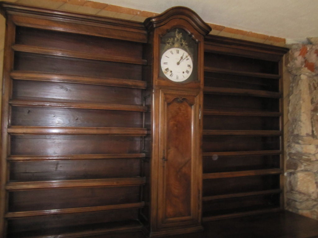 Sensational Régence-Provincial Walnut Vaisselier/Buffet. Cornice sits upon a lovely facade featuring a central clock above a paneled door flanked by open shelves. The weight driven clock with porcelain face features a cockerel and is inscribed