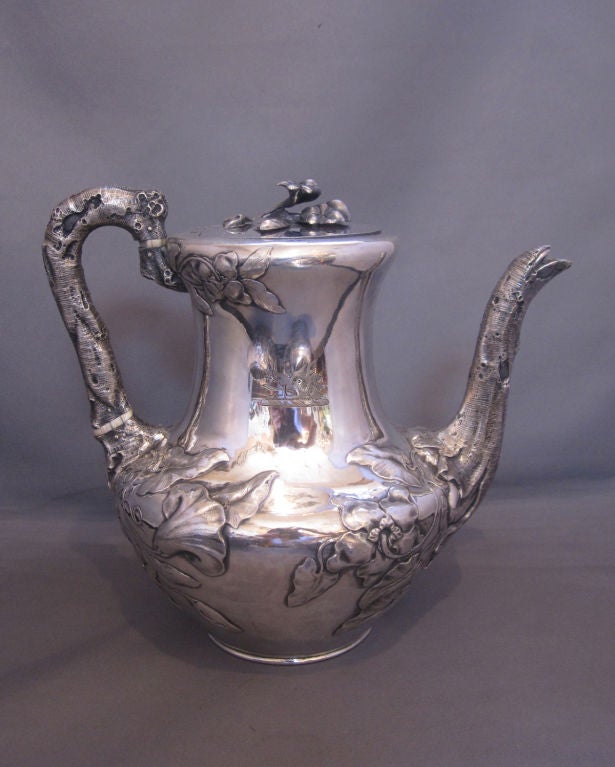Fabulous English sterling silver four (4) piece tea and coffee service by John Figg of London, 1839-40, with high repoussé floral relief, floral finials, the handles formed as branches, sugar and creamer with gilded interiors.  All pieces with a
