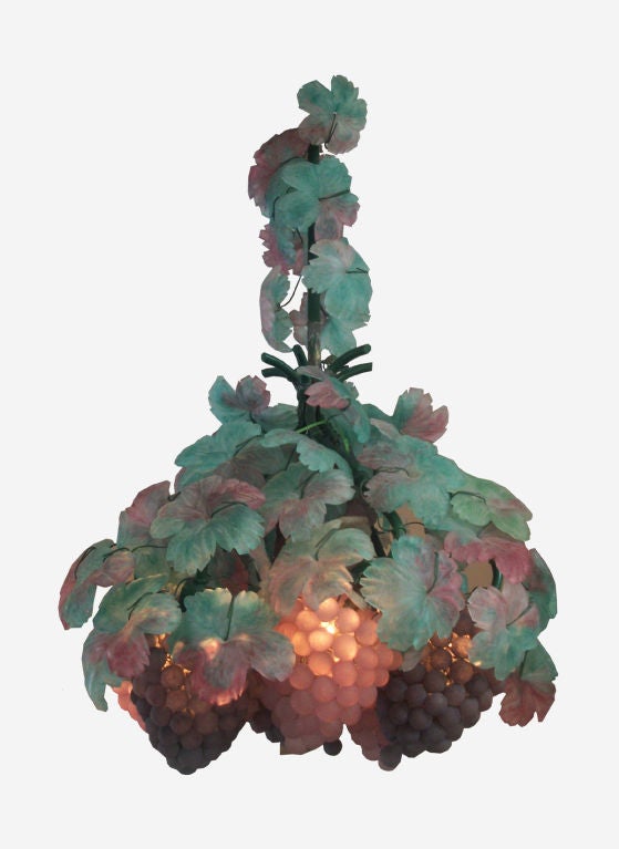 Beautiful Murano six light multi-colored chandelier with glass leaves surrounding six glass grape cluster shades.