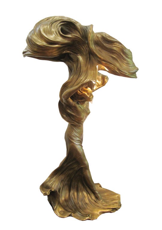Modelled and cast in gilt bronze as the celebrated dancer with swathes of fabric swirling above her, with light fitments, signed Raoul Larche with foundry seal for SIOT DECAUVILLE FONDEUR PARIS and stamped 33.