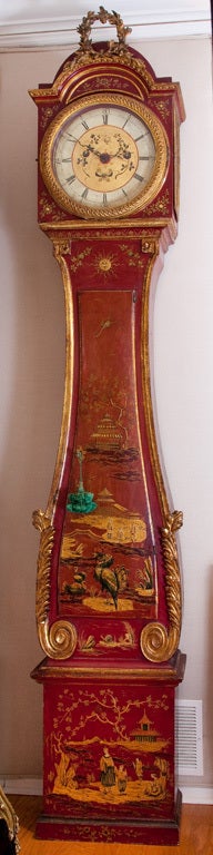 Tall and imposing Red Lacquer Longcase Clock with beautiful painted Chinoiserie designs of landscapes, rooster and birds, snails, foliage and characteristic sun faces, the case decorated with carved gilt wood scrolls, foliage, Greek key border and