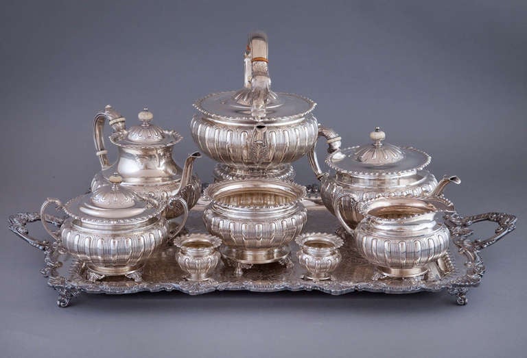 Sensational sterling silver oversized 8-piece tea and coffee service by Frank Whiting of North Attleboro, Massachusetts, circa 1896-1900, with hand chased gadrooning on the bodies, foliate rims, handles with acanthus leaf decoration, all standing on