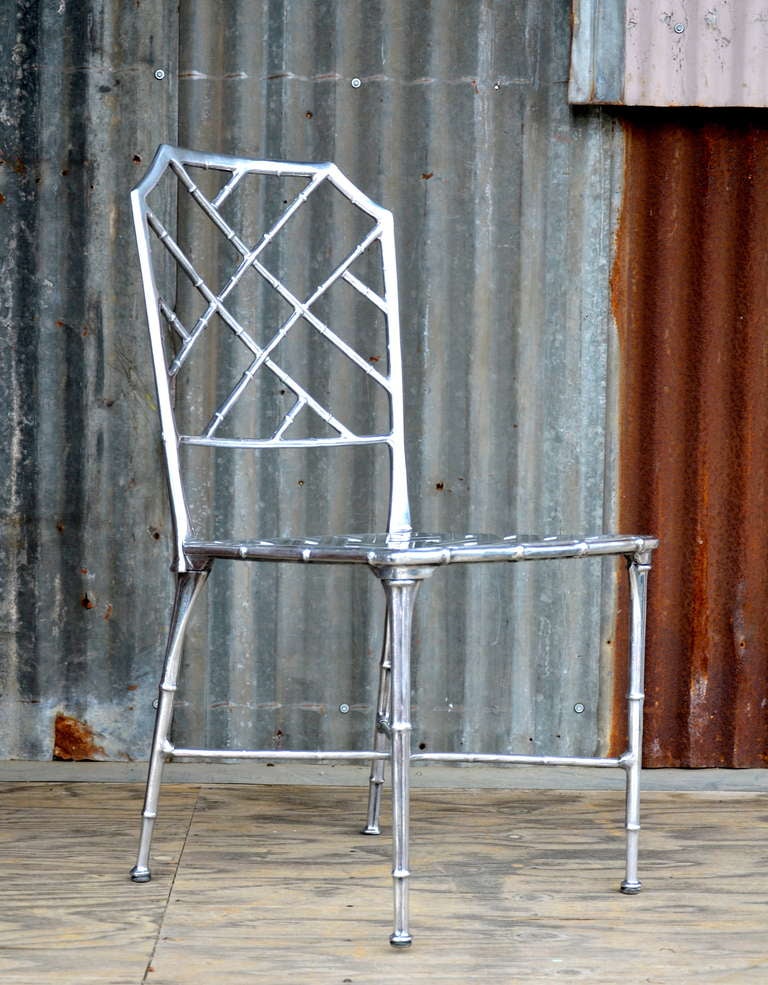 Striking pair of polished aluminum side chairs by Brown Jordan. Nice quality casting.