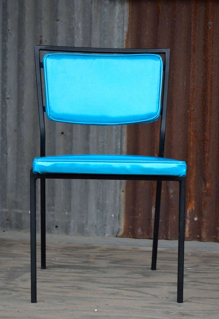 A simple and modern form upholstered with playful blue sparkle vinyl.