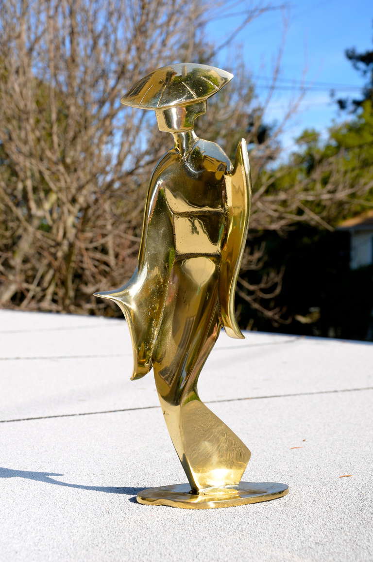 Large polished brass geisha sculpture. This decorative statue stands 18