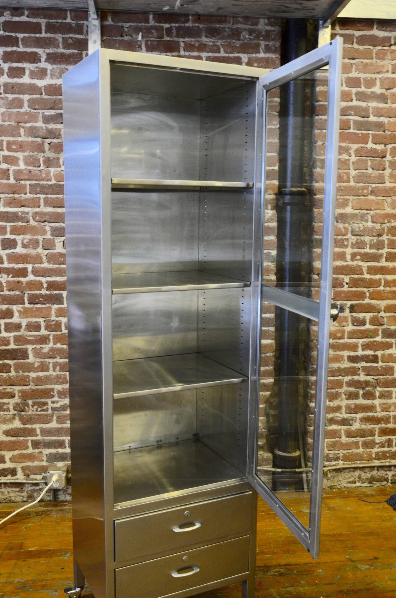 Excellent for storage and display! This classic stainless steel cabinet is tall and narrow making it a perfect choice where space is limited. This model has 4 shelves and 2 drawers. I have several of this size, please inquire.

Please feel free to