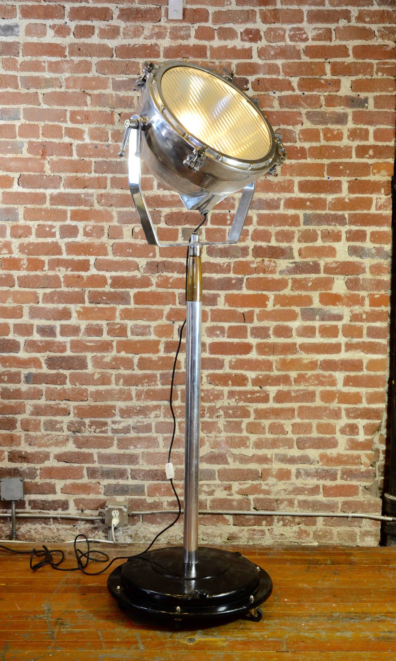 These exceptional fixtures are decommissioned WWII aircraft carrier spotlights. We've painstakingly restored, and polished them for re-assignment in the 21st century. Mounted to heavy duty Industrial iron bases and rewired for standard bulbs.