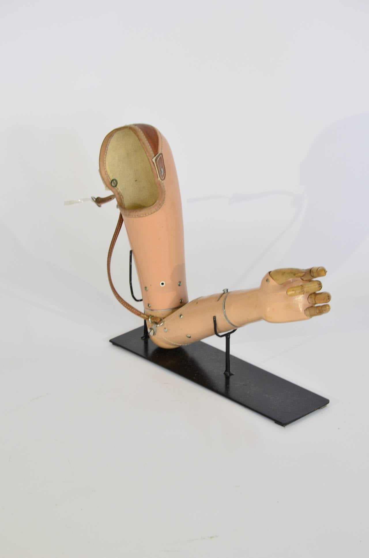 Nice early prosthetic arm with articulated fingers. This 1930's device was top of the line for its time. Excellent conversation piece. Custom display stand.

Please feel free to contact Polished Modern directly for best pricing and shipping