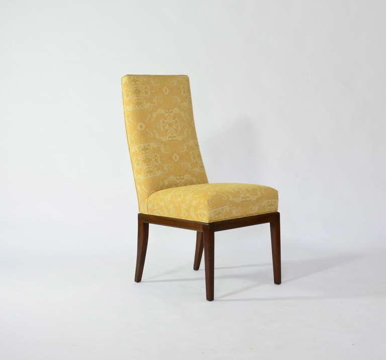 Nice set of 8 dining chairs in the style of Michael Taylor. Vintage upholstery and elegant walnut frames.