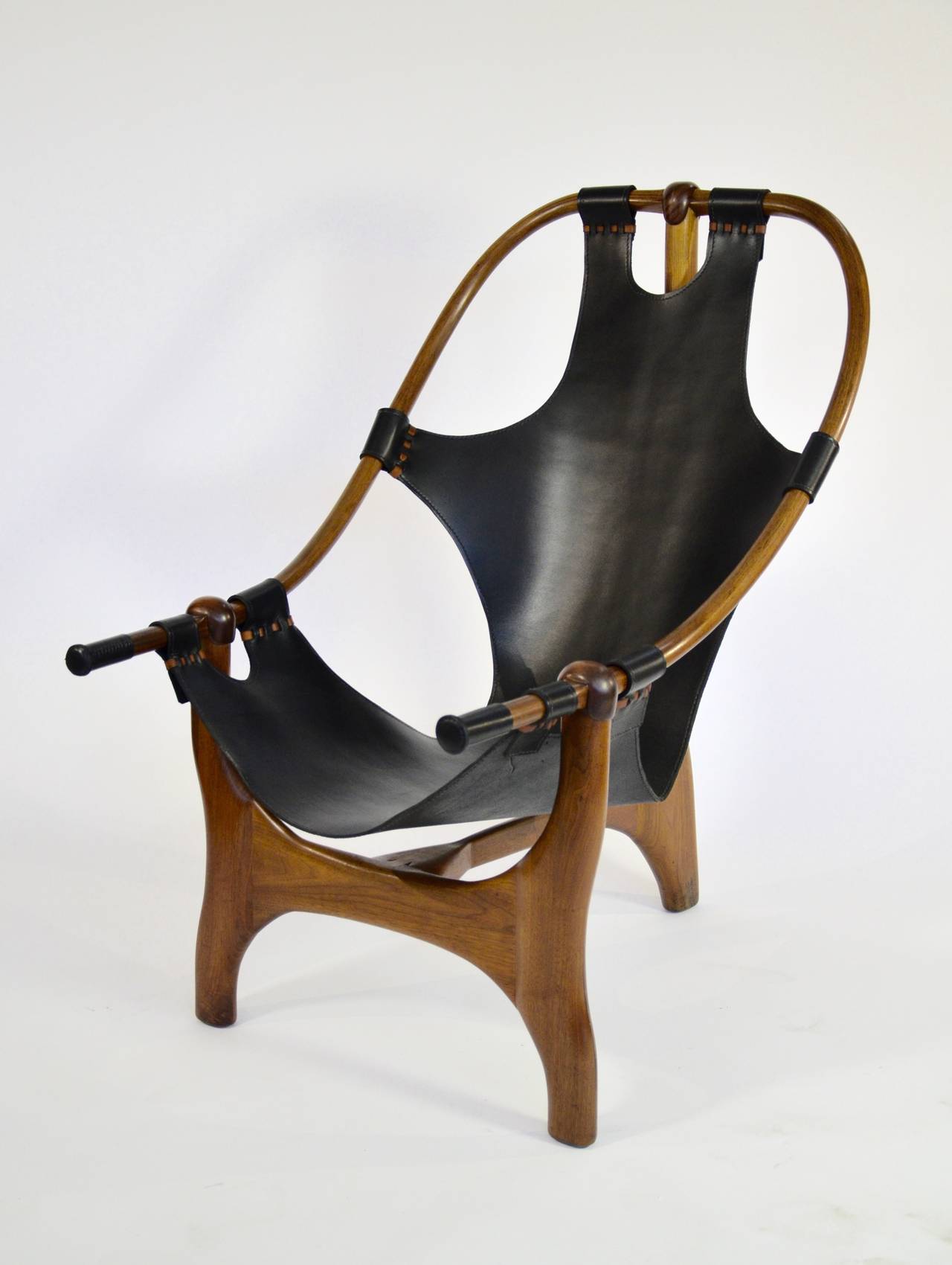 This one of a kind chair was found in Berkeley California, where some amazing Studio furniture was being turned out in the mid-20th century. Built from stacked laminated walnut, this sling design is an engineering marvel. This chair has been