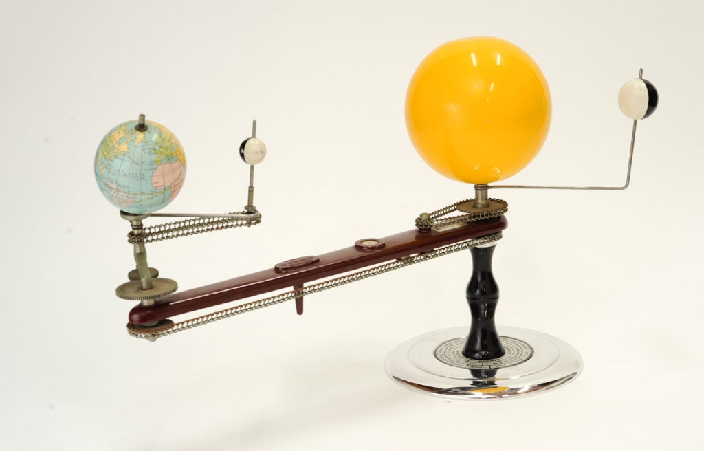 Excellent man cave accessory. This geared tellurium features a spinning and revolving terrestrial globe, revolving spherical black-and-white representation of the moon, central plastic yellow sun, and a black and white representation of Venus. Very
