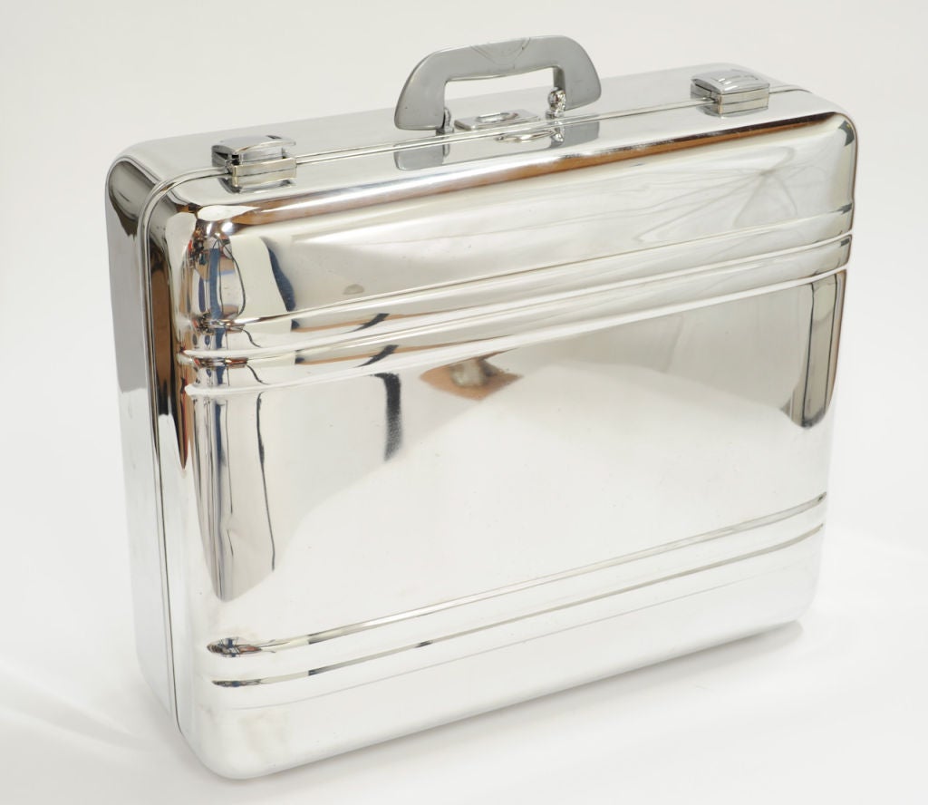 Polished aluminum suitcase by Zero Halliburton. Excellent for visual display. Locks with combination.