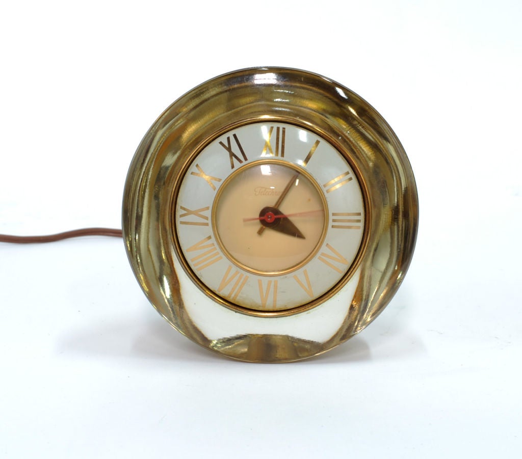 Very chic table top clock by Telechron. Inner casing gives the glass a pleasant bronze tint. Runs great.
