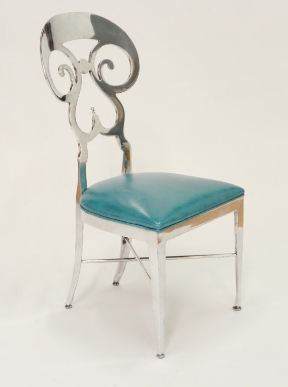 Polished aluminum side chairs with turquoise leather upholstery. Fun! Priced as a set of four.