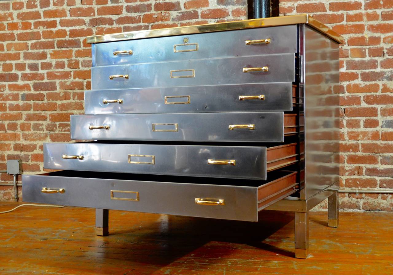 *This item is eligible for FREE domestic shipping through December. Please contact Polished Modern for details.* Exceptionally handsome steel cabinet with brass hardware. Excellent for art storage, and as a dresser. Has a burgandy Formica top.