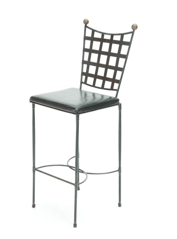 Set of three iron stools with upholstered seats by John Goode.