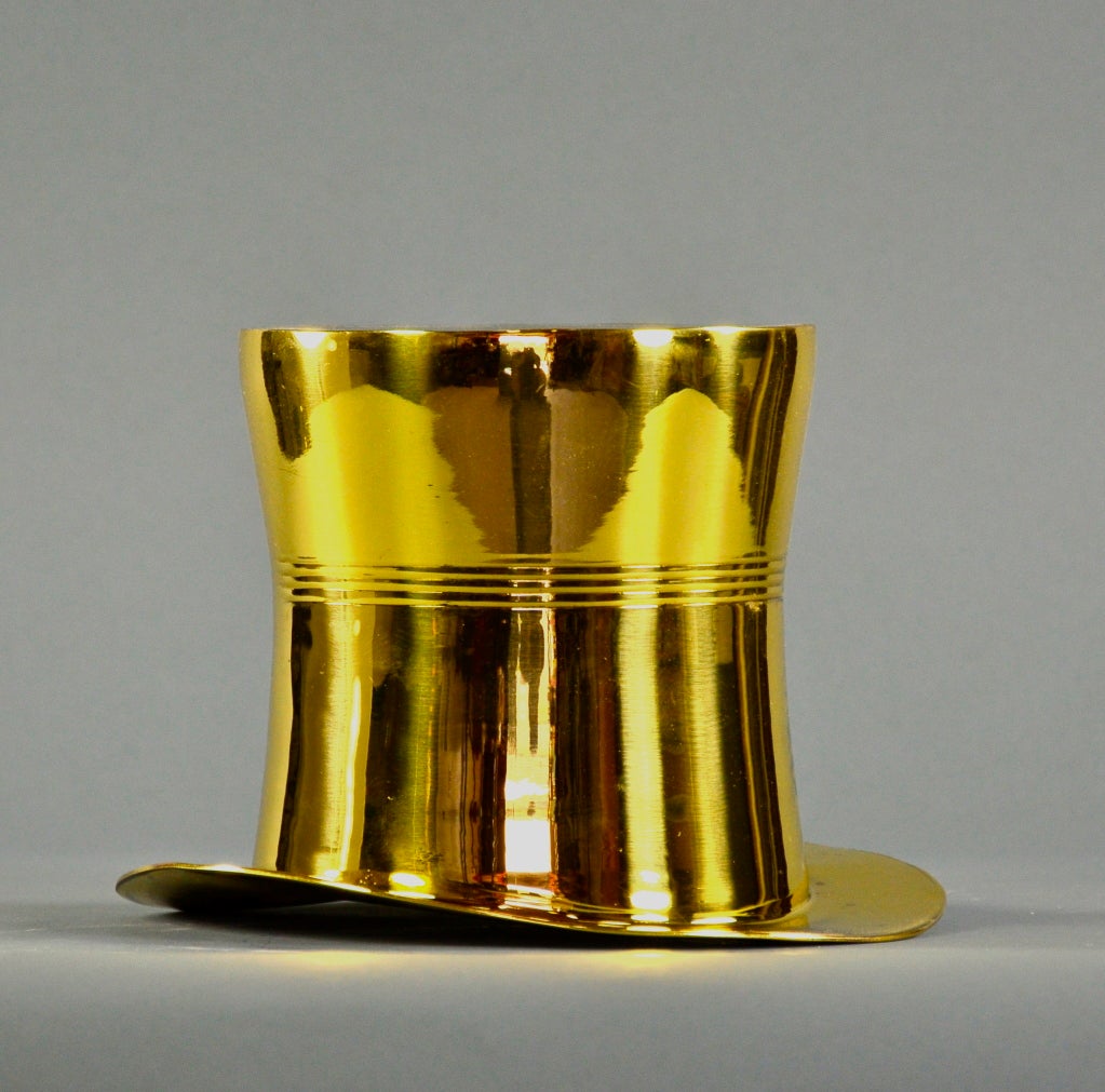 Unusual top hat ice bucket rendered in solid brass.
