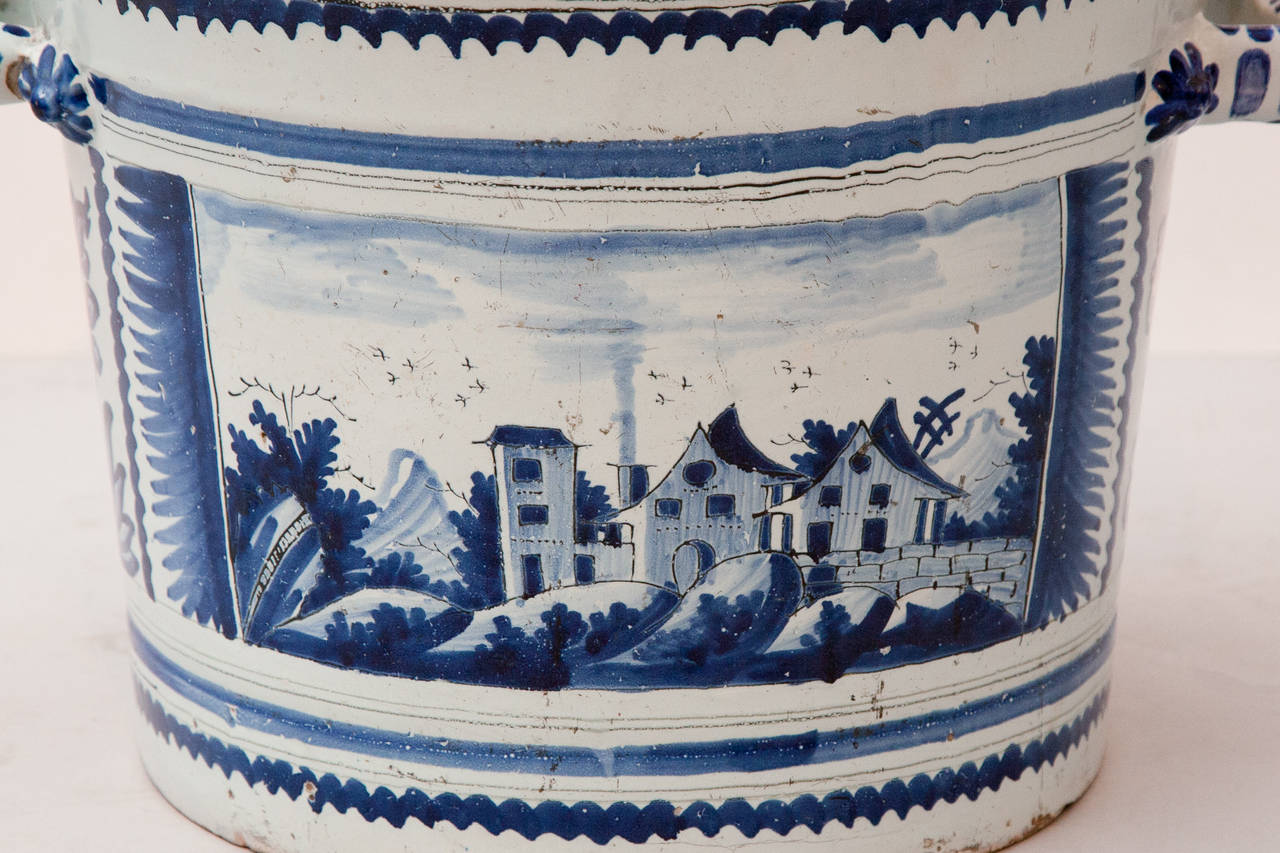Decor de camaieu bleu representing the same view of a village on both sides.

It was due to Louis XIV that Nevers became celebrated for the production of faïence. Towards the end of the 16th century he bought 
Augustin Conrade a potter from