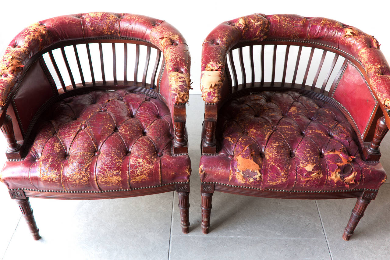 Carved legs and arm supports, and upholstered in Moroccan leather. 

In country house worn condition as pictured.
