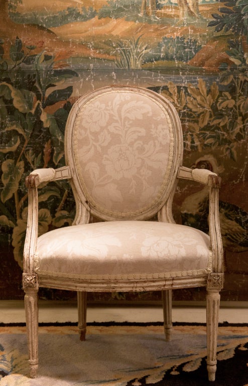 Louis XVI chair with orignal paint. Fluted legs with carved scroll arms.

New upholstery.