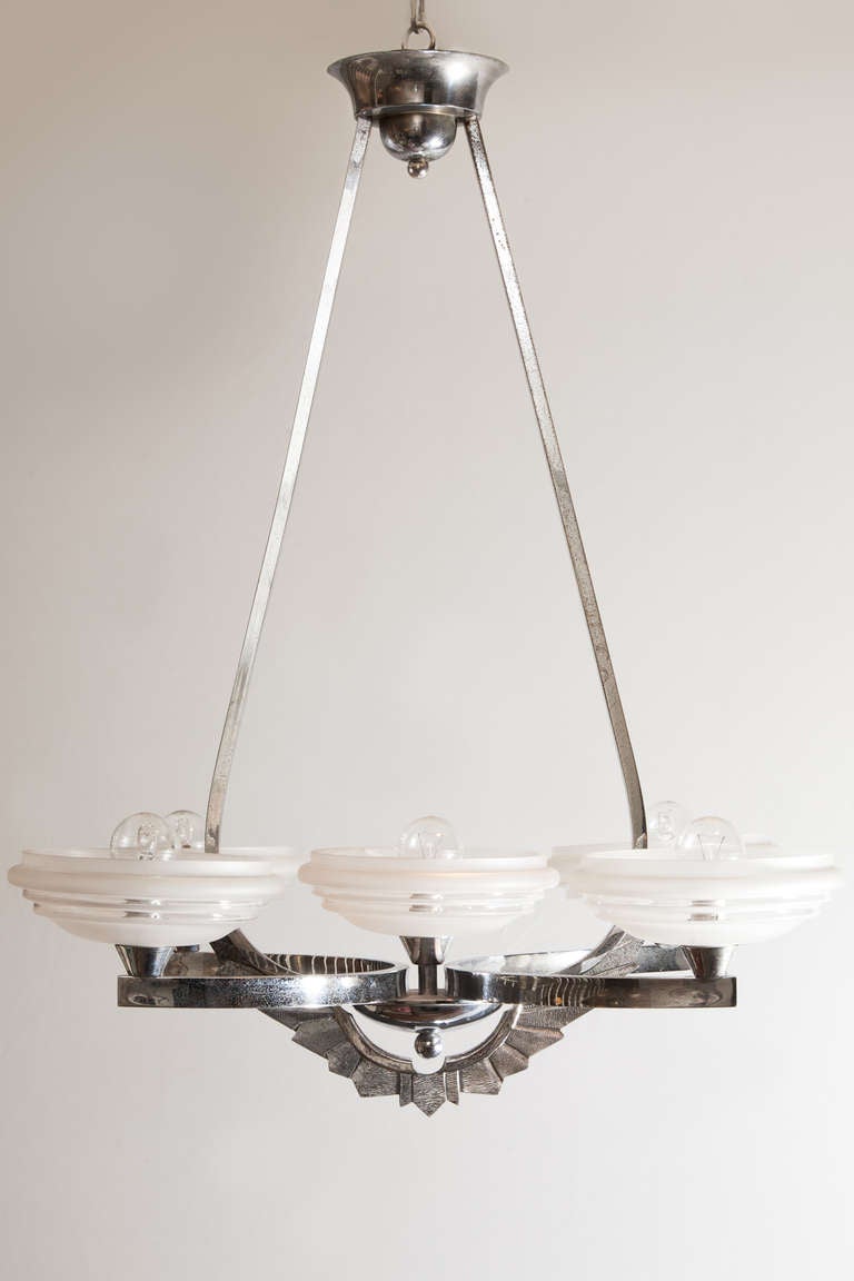 French 1930's chrome plated bronze chandelier with five etched glass dishes, four on arms and one central. Hanging on two curved arms from circular ceiling canopy with geometrically decorated apron.

Currently electrified for the UK.