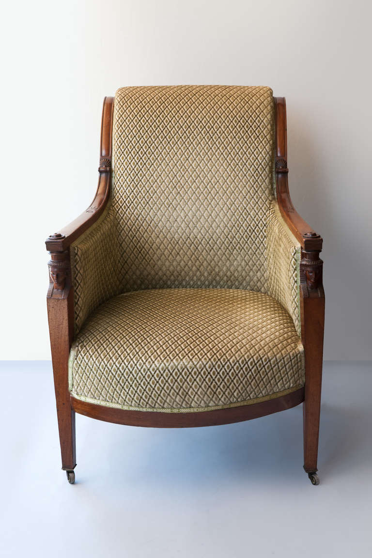 Straight front legs topped with carved Egyptian heads & anthemion. The back with a gentle roll on original castors. 
The chair can be attributed to Jean Baptiste Bernard DEMAY 1759-1848, known for his good quality  seat furniture he was elected a