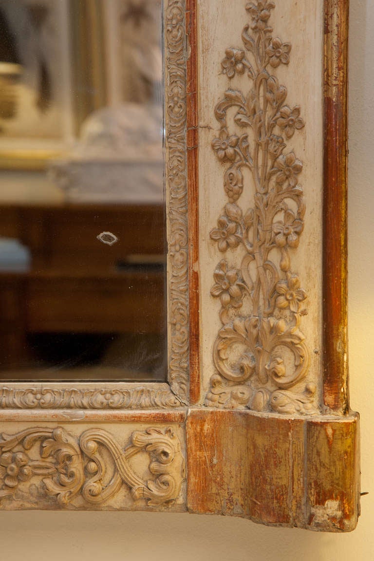 Mid 19th century French over mantle mirror with raised decoration on the centre of the sides. Originally gilded with later mercury mirror.
The mirror was probably originally gilded all over but most of the hiding has now gone and it is a gentle