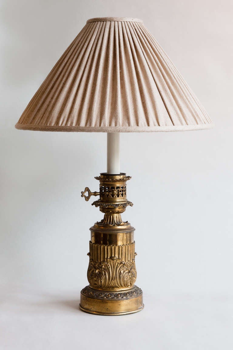 Single table lamp converted from a 19th century French oil lamp with cast brass acanthus leaf decoration.

Currently electrified for the UK. This lamp could be electrified for the US for a small extra cost.

Shade not included.