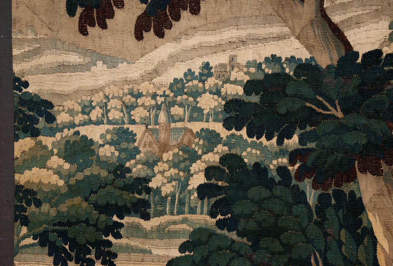 A wooded scene with trees, leaves, ducks and dogs.

Woven in wool and silk.