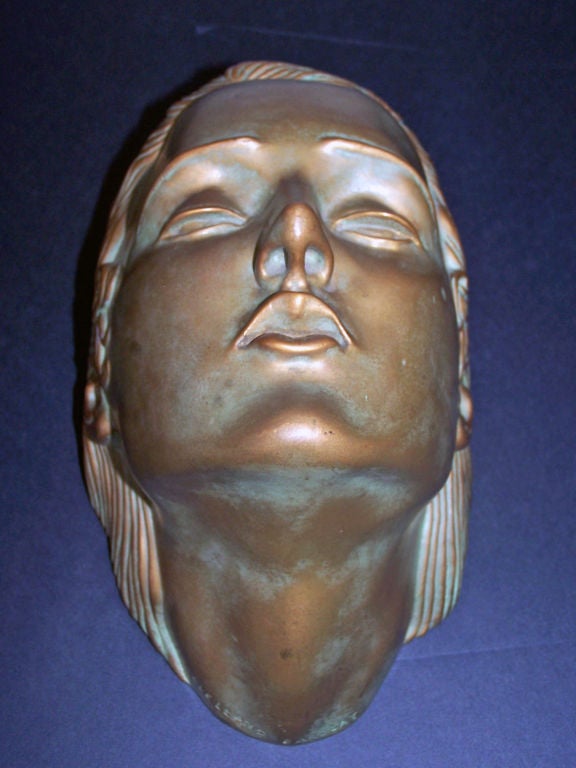 Bronze sculpture of a Woman's Face/Head by McClelland Barclay.<br />
Signed on lower neck.