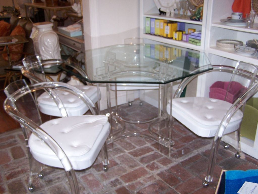 Lucite Dining Set Four Chairs and a Hexagon Glass Table Top with beveled edges.  Some wear and tear to the original white fabric.