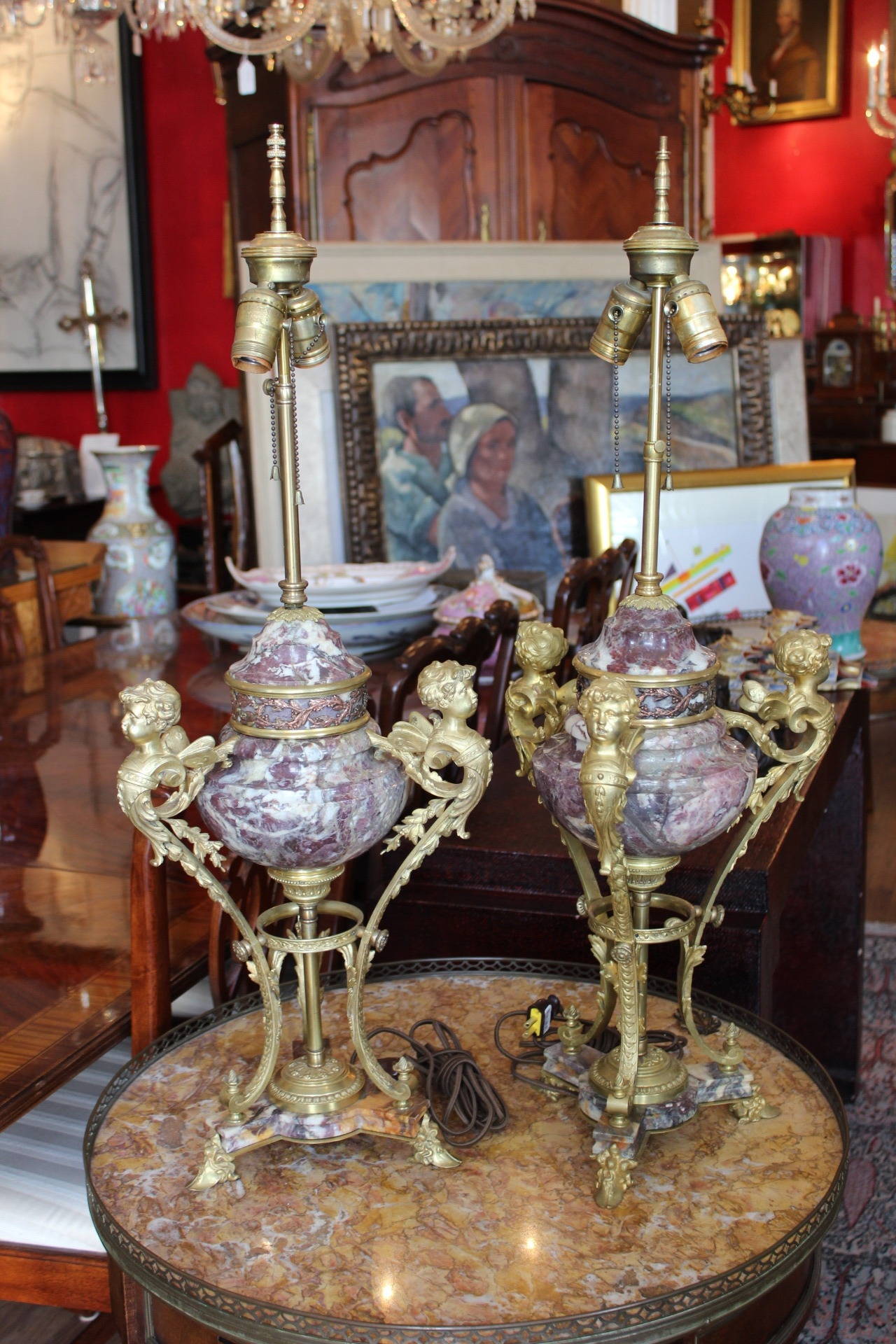 Second Empire French bronze-mounted marble lamps. Marble is surrounded by three winged putti.