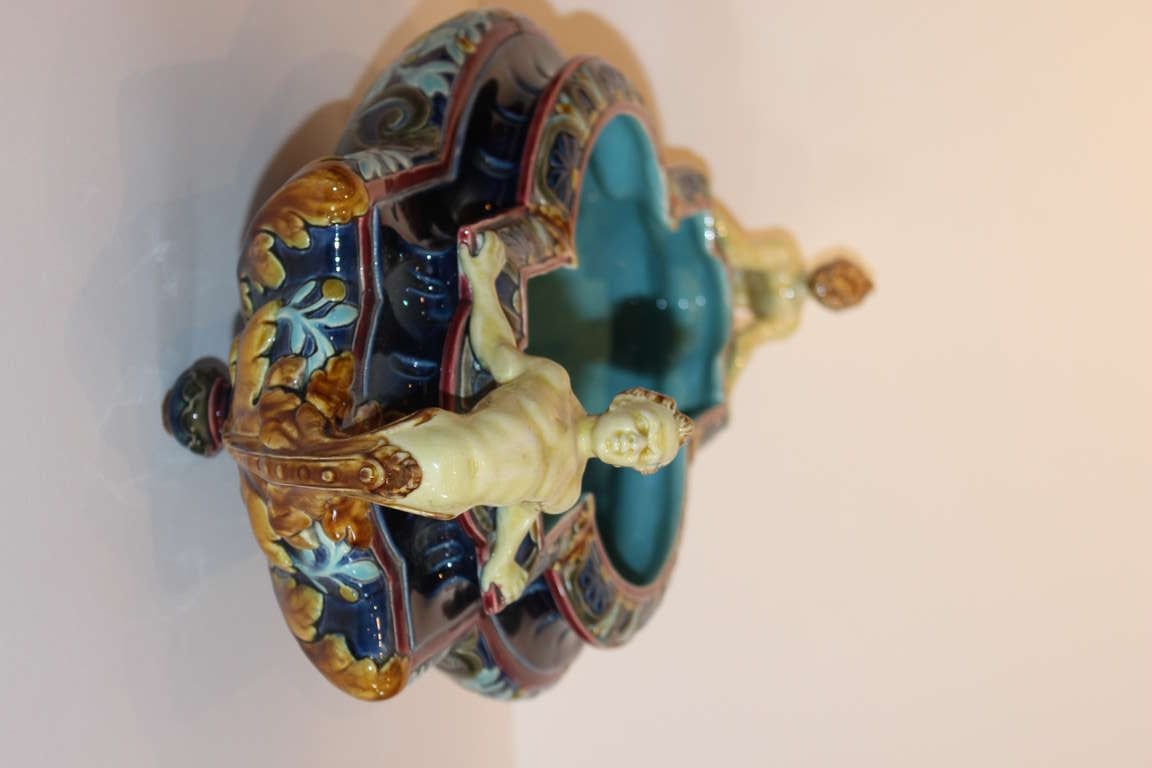 French Sarreguemines Majolica pottery Center Bowl with satyrs acting as handles raised up on four round feet.  Marked on bottom with an inset 1038, 207 and Sarreguemines.