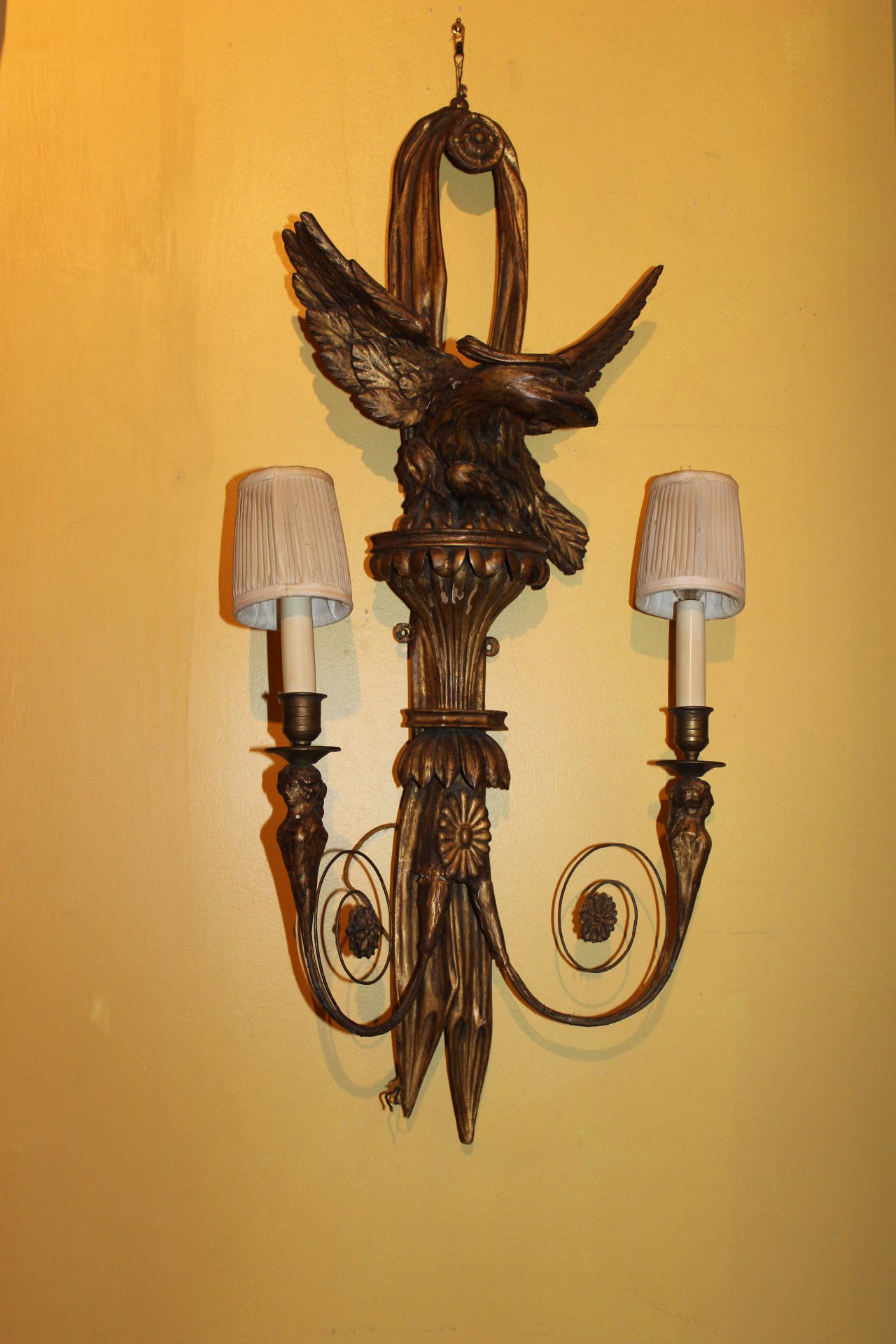 Pair of Italian gilt carved wood eagle scones. Once candle sconces, probably electrified in the 1940s. Eagle wing span is 11