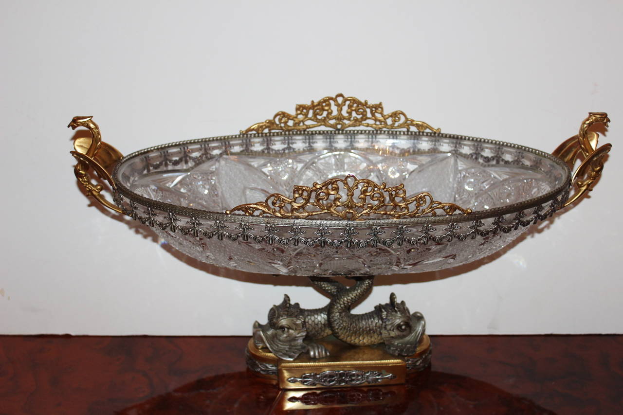 Large Italian gilt bronze, silver and crystal compote. Art moderne style, with a two dolphin base, cut crystal bowl and swan handles.