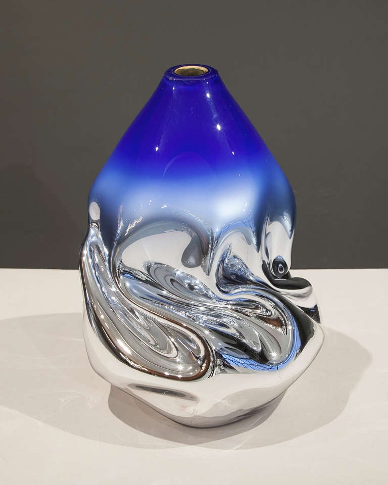 SG1612

Unique crumpled sculptural vessel in silver mirrorized translucent hand-blown glass with royal blue top. Designed and made by Jeff Zimmerman, USA, 2014.