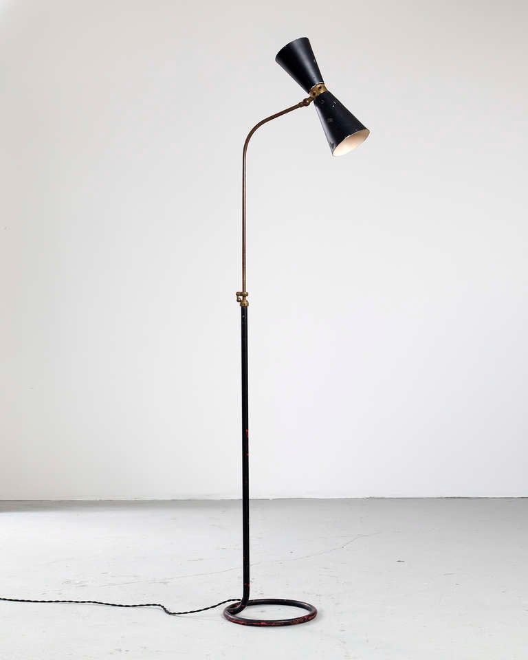 Floor lamp in brass with double cone shade in black enameled metal. 