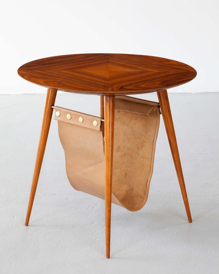 Round coffee table in pau marfim wood with magazine holder. Designed by Joaquim Tenreiro, Brazil, 1960s.