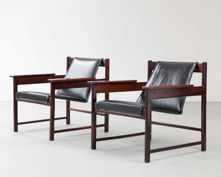 Pair of lounge chairs in black leather and jacaranda. Designed by Sergio Rodrigues, Brazil, 1960s. (seat: 16