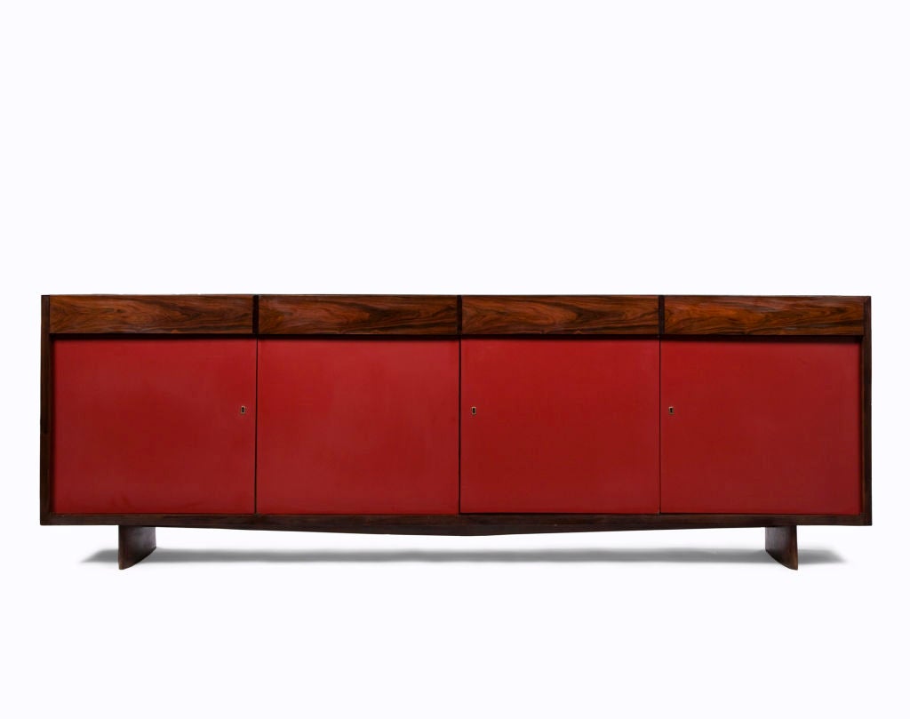 Four-door credenza in jacaranda with red formica front. Designed by Joaquim Tenreiro, Brazil, 1948.