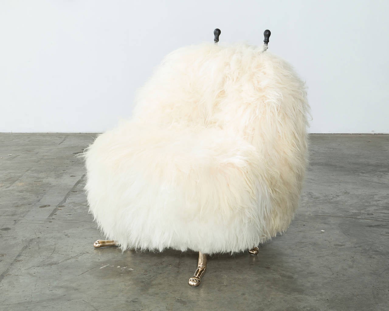 CH889

Unique Hairy David Beast chair in white Icelandic sheepskin with cast bronze feet and carved ebony horns. Designed and made by The Haas Brothers, Los Angeles, CA, 2014.