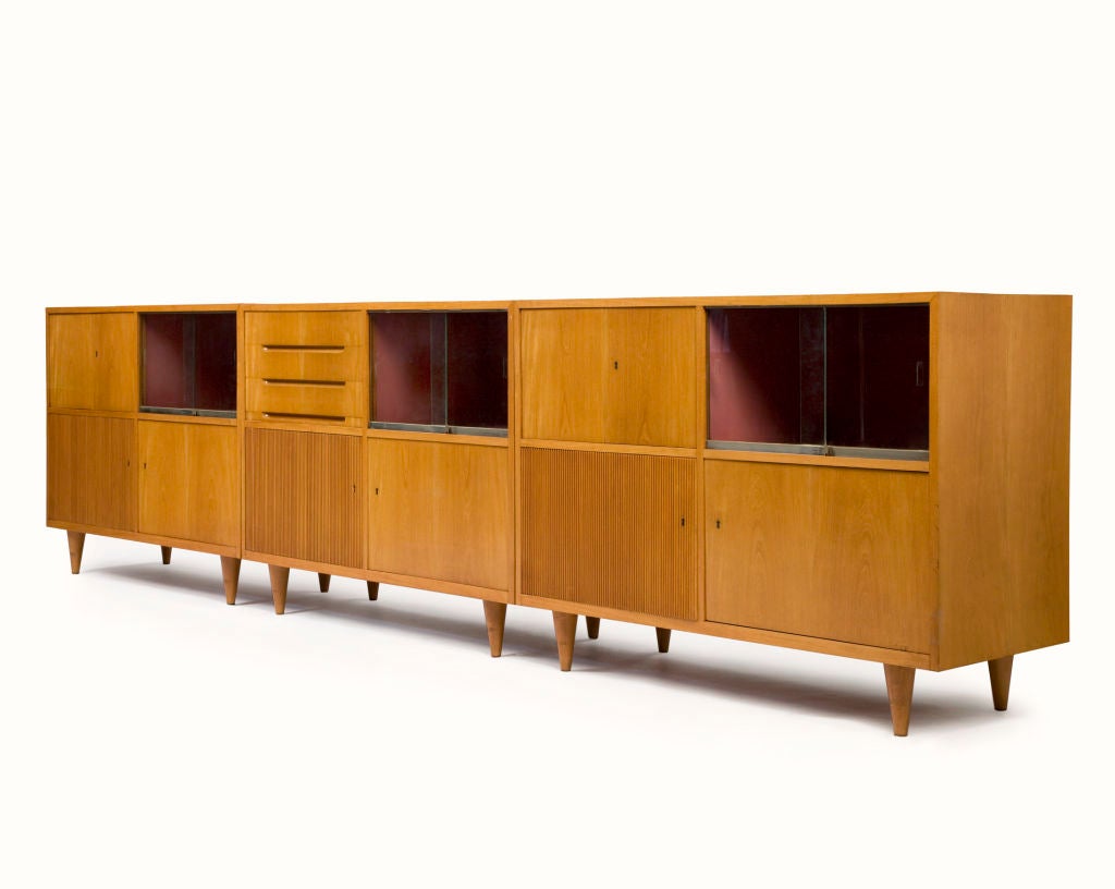 Custom-made credenza in three separate sections, in caviona wood. Designed by Joaquim Tenreiro for a private commission in the Flamengo neighborhood of Rio de Janeiro, Brazil, 1950s. (measurements are for each section; total 147